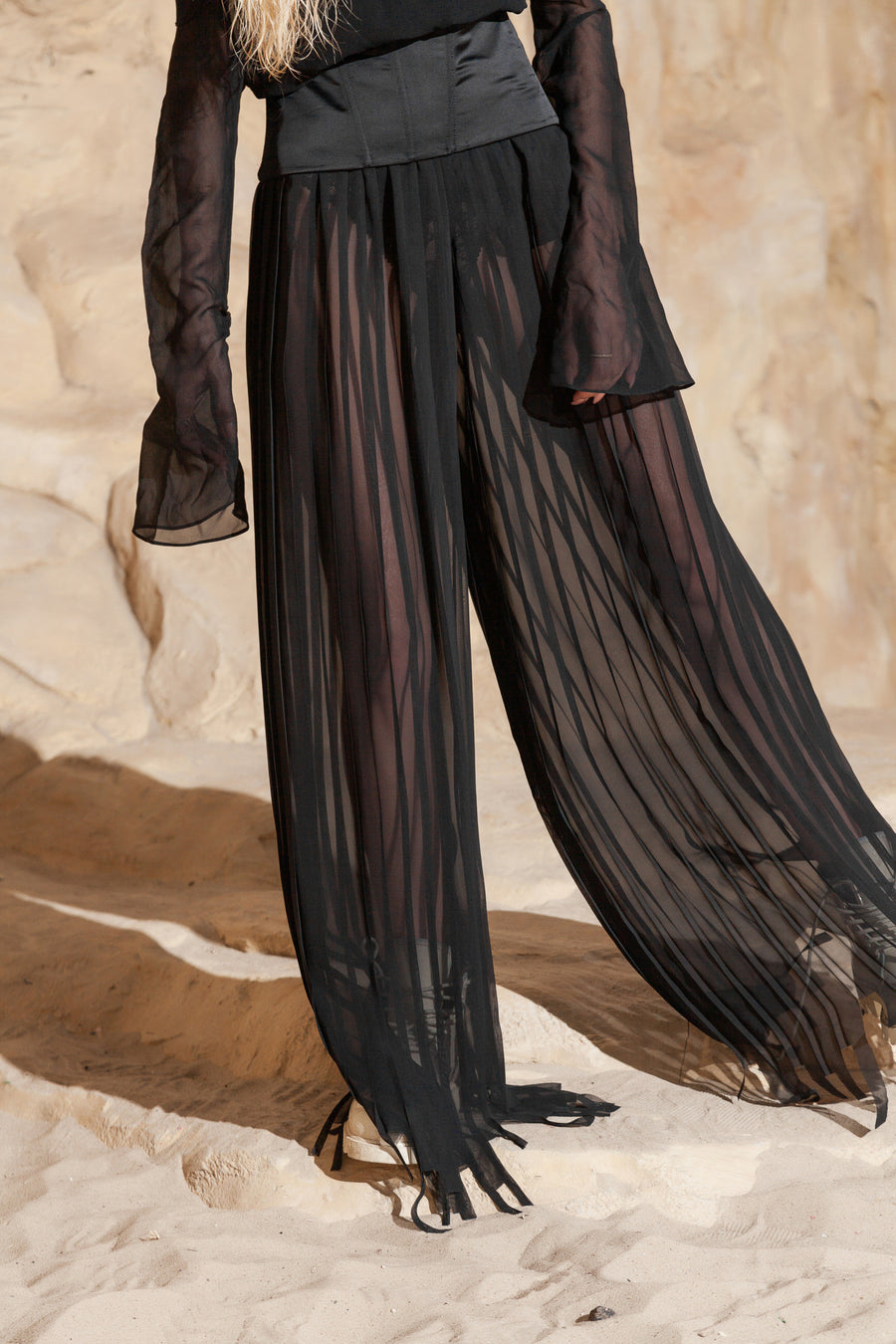 PLEATED PANTS WITH ASYMMETRICAL HEM